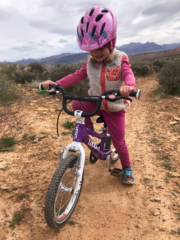 child struggles to ride a bike