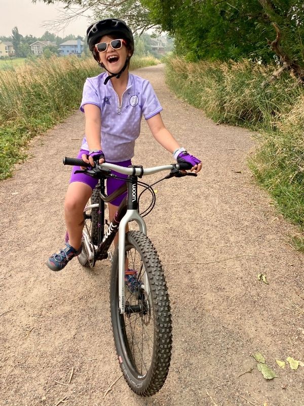 Girl laughing while riding her bike