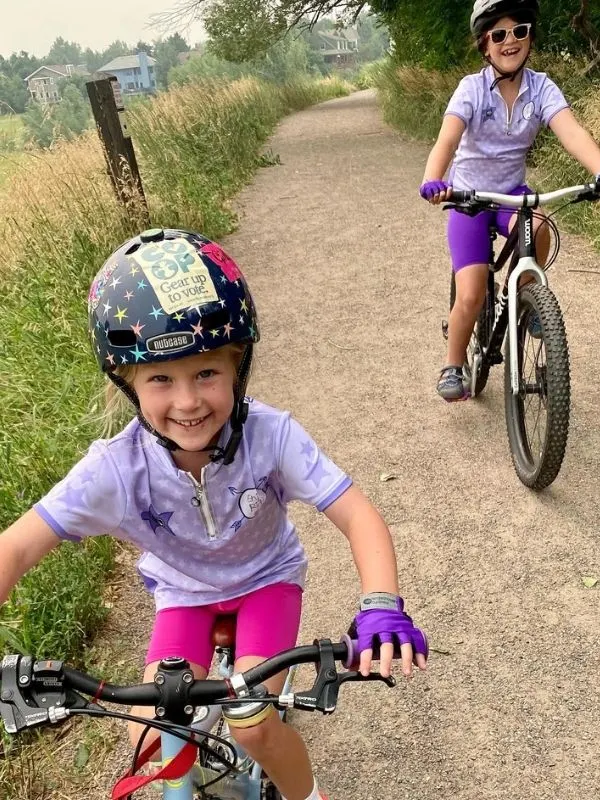Sisters biking and smiling