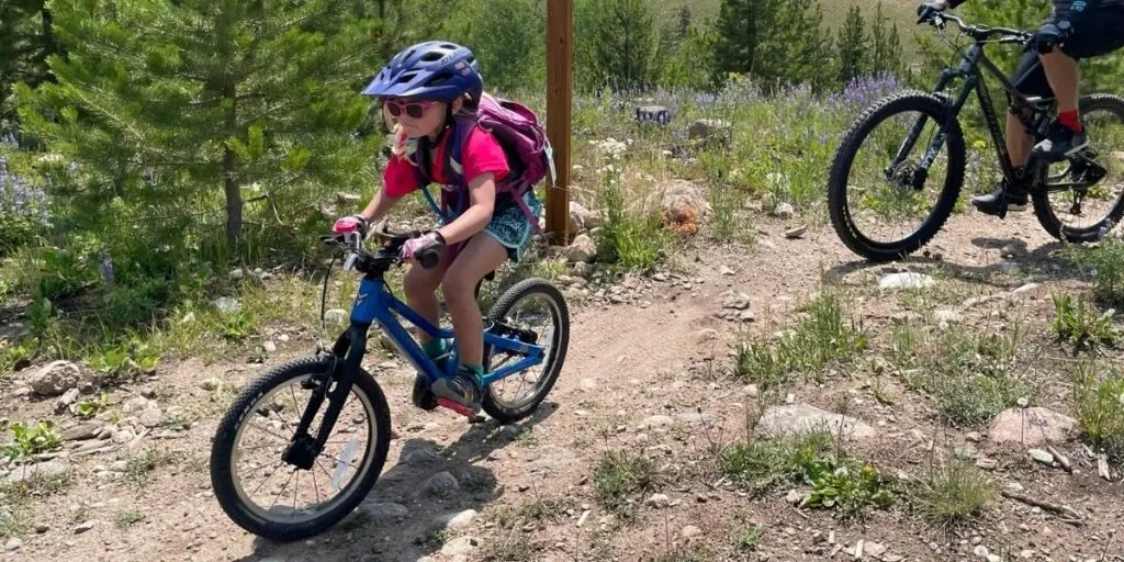 Girl riding Prevelo Alpha Two bike on a dirt path