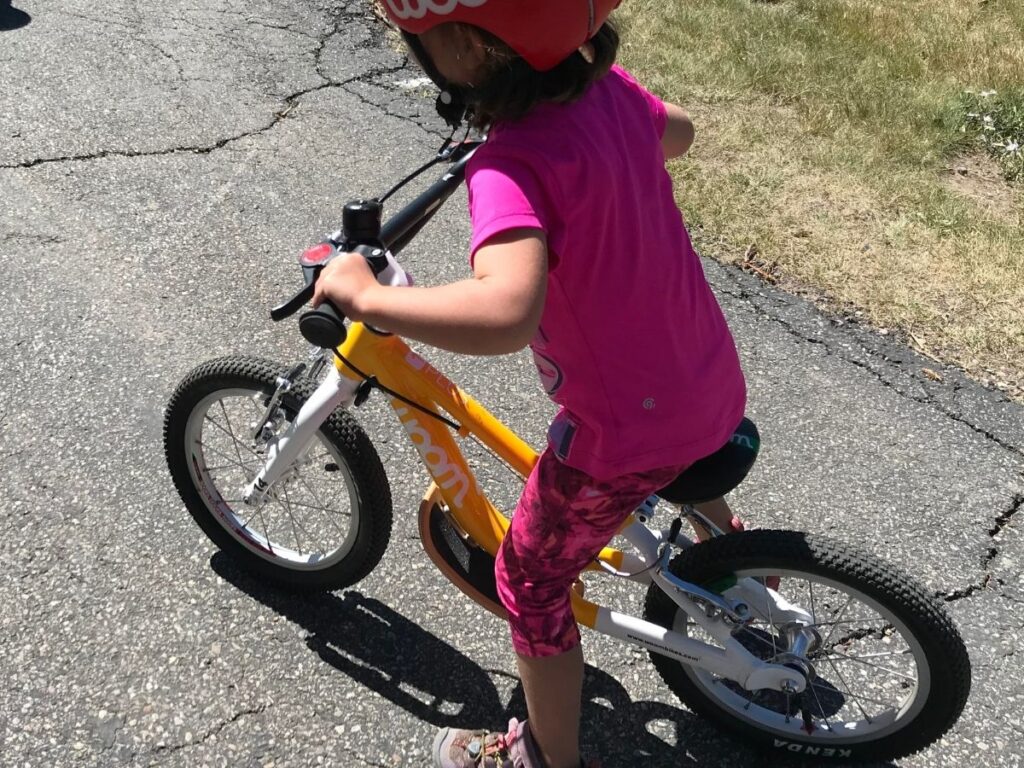 Woom 1 plus review - girl riding the bike