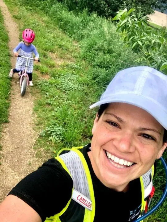 Mom on a run with toddler on a balance bike, both are happy!
