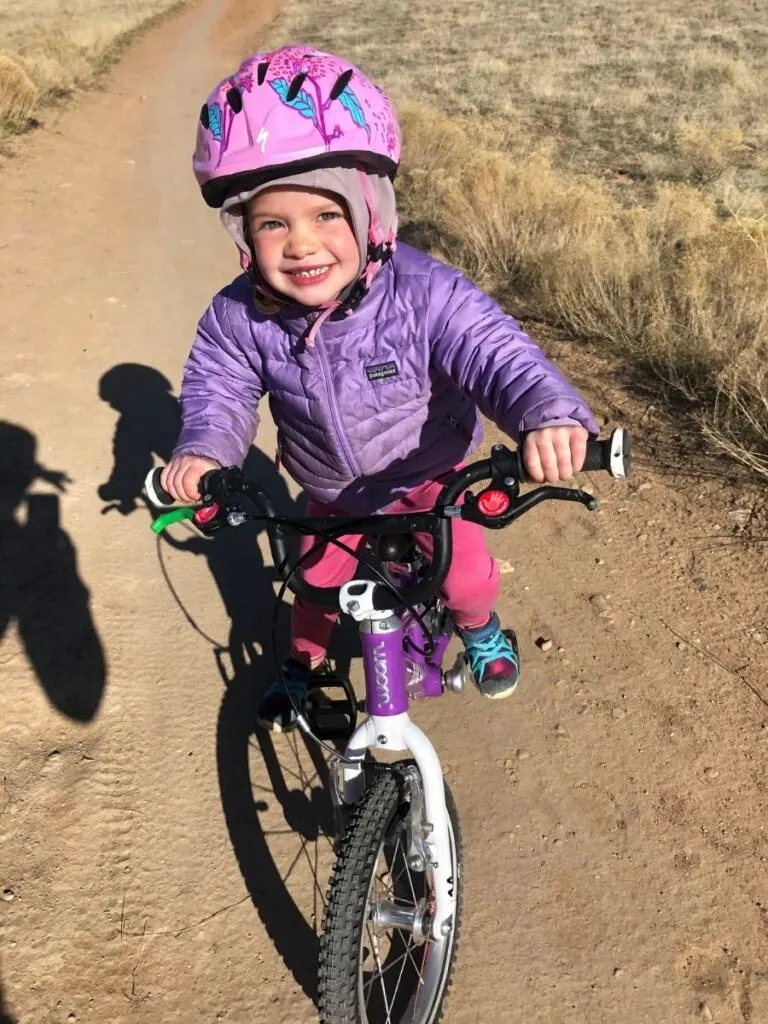 Harper is all smiles as she rides singletrack for the first time. 