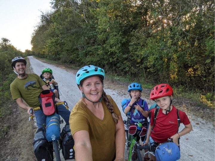 A family of five on bicycles