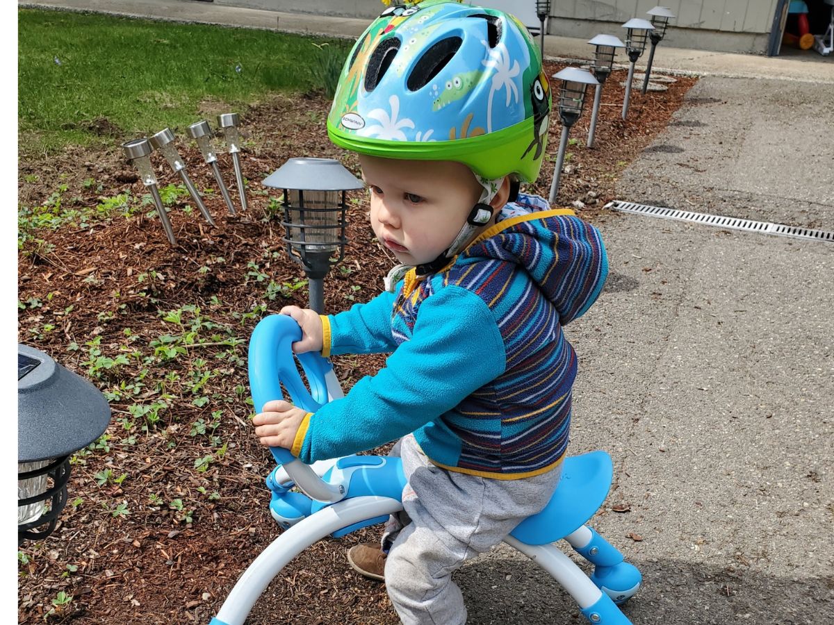 bike helmet review update horizontal - 1 Little boy riding a toy with a helmet on