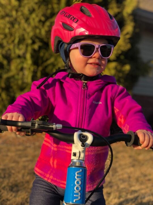 small girl wearing pink bike helmet