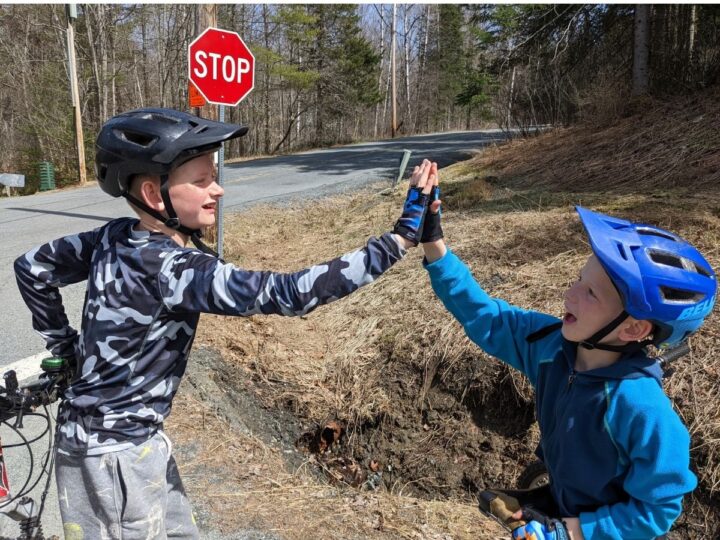 Boys high five after biking