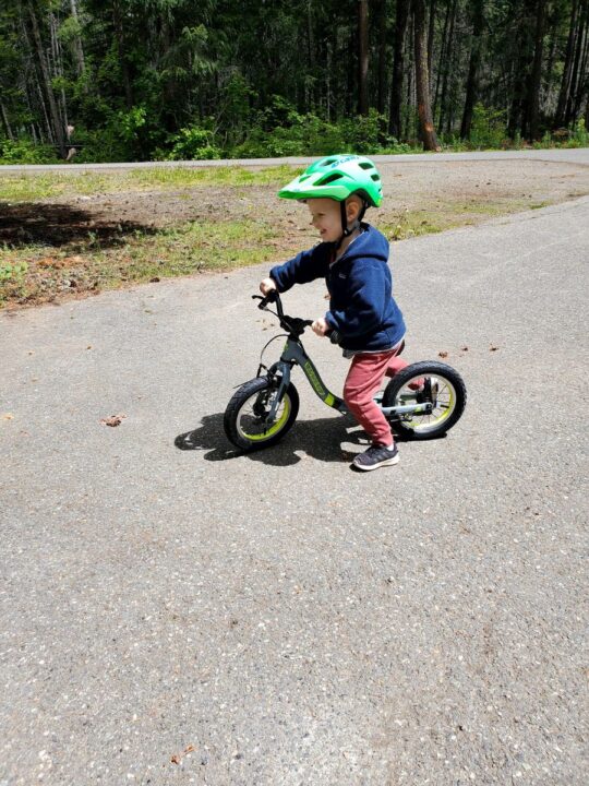 little boy smiling while riding balance bike. Guardian balance bike review. 