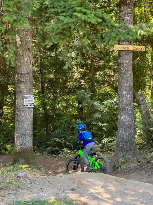 Photo of a child riding a bike down a trail labeled "Cheech & Chong's"