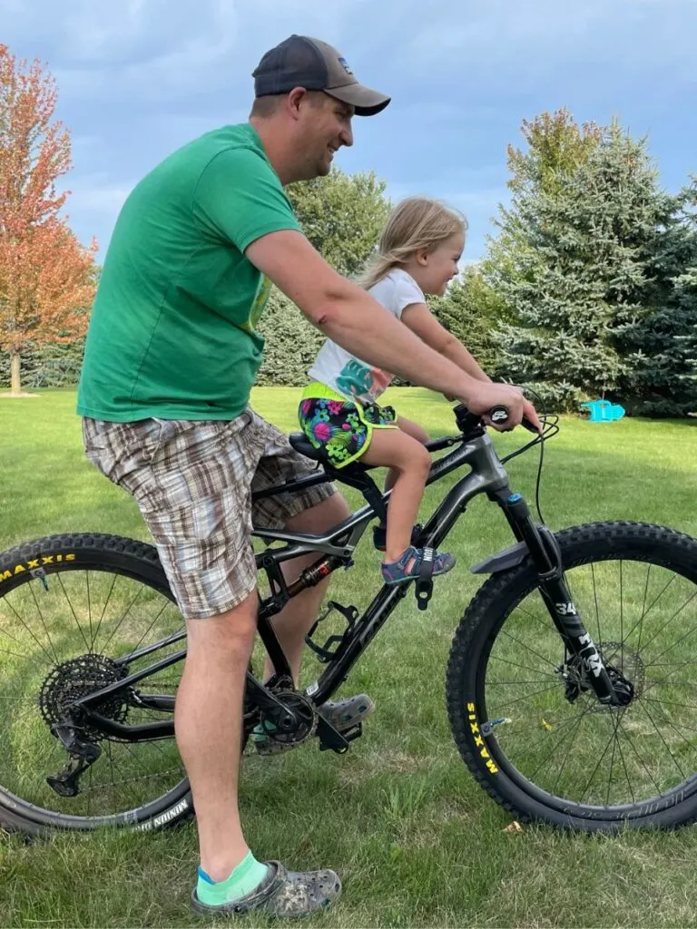 Dad and daughter demonstrating body position on a mountain bike with the shotgun pro seat.