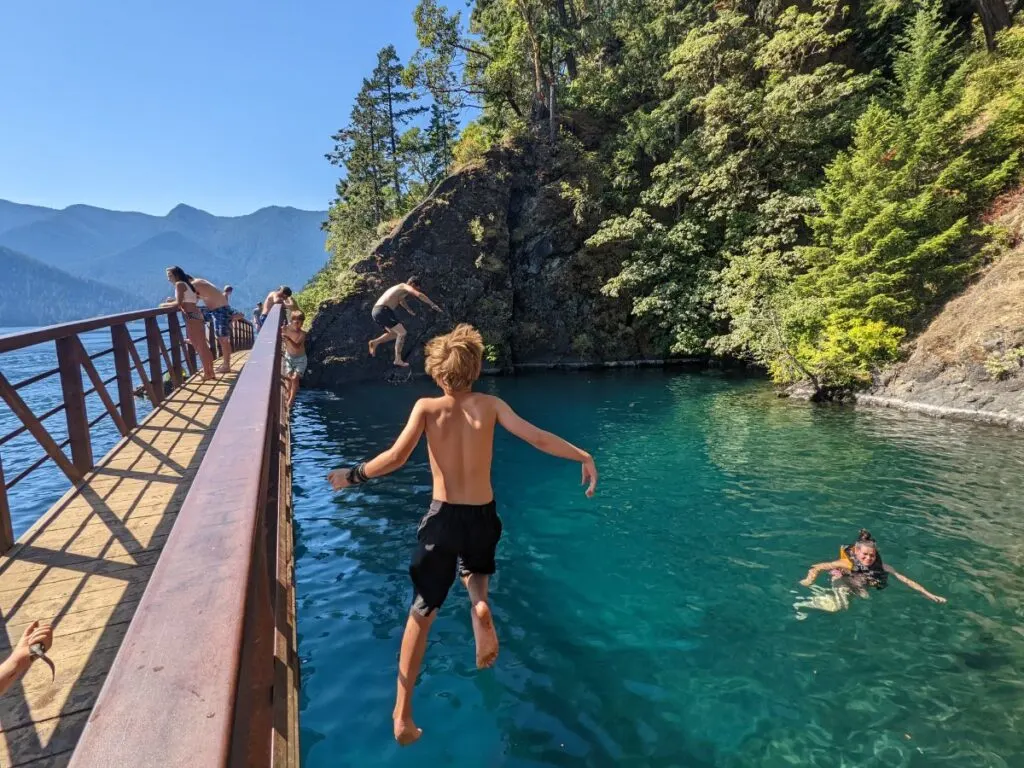 A boy jumps into a lake