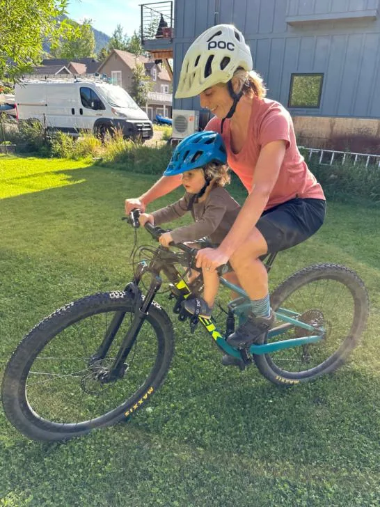 Woman and toddler ride mountain bike together using Kids Ride Shotgun 2.0