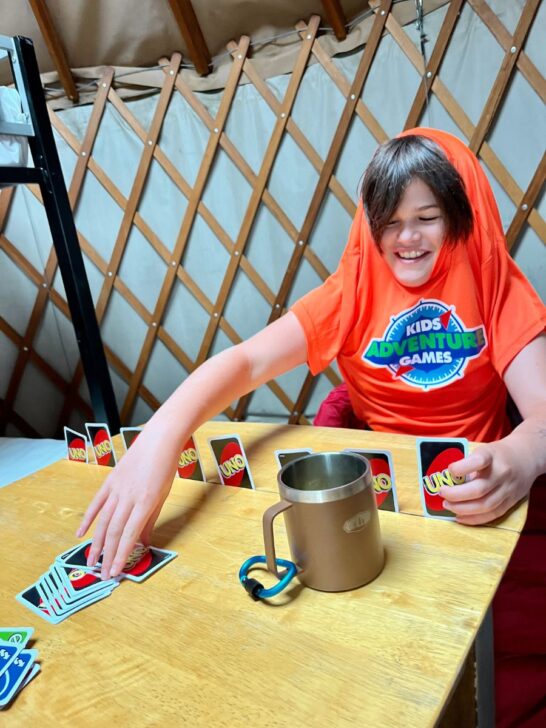 happy kid playing cards