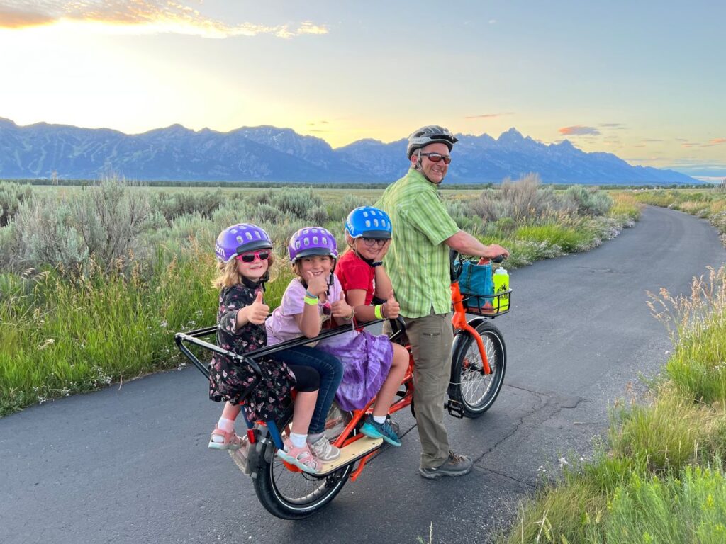 Dad and three daughters on a cargo bike