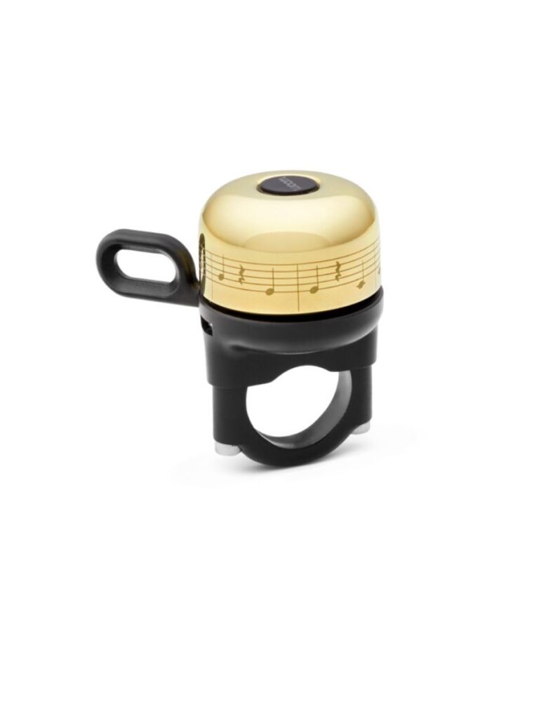 A stock photo of a golden bike bell with musical notes