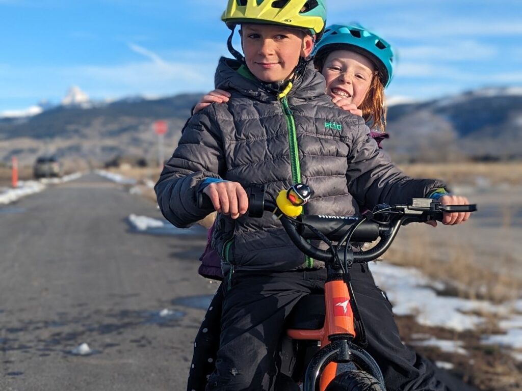 Two kids ride double on the Himiway E-bike.
