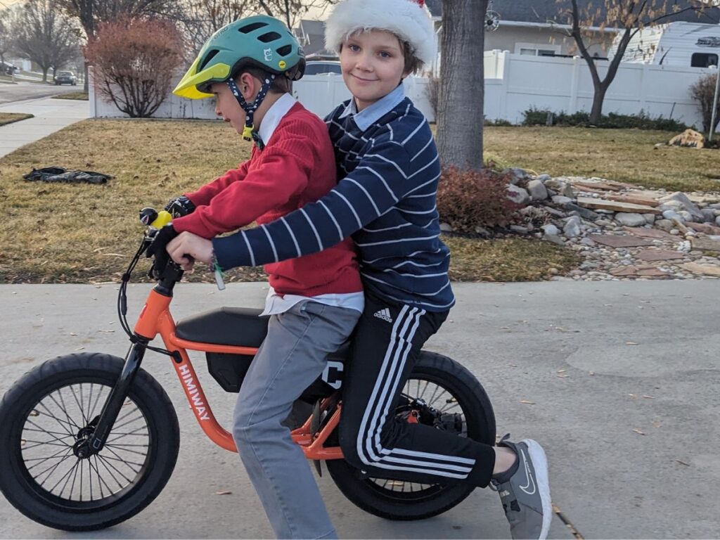 Two boys ride double on the Himiway e-bike.