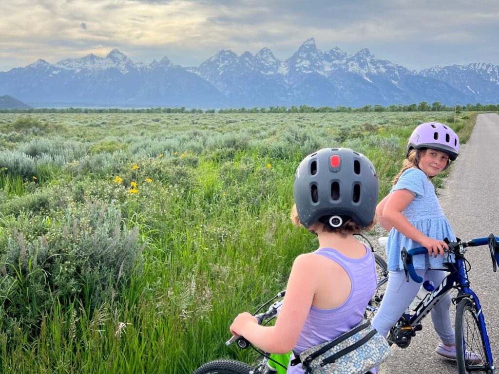 Girls biking using the Woom READY helmet