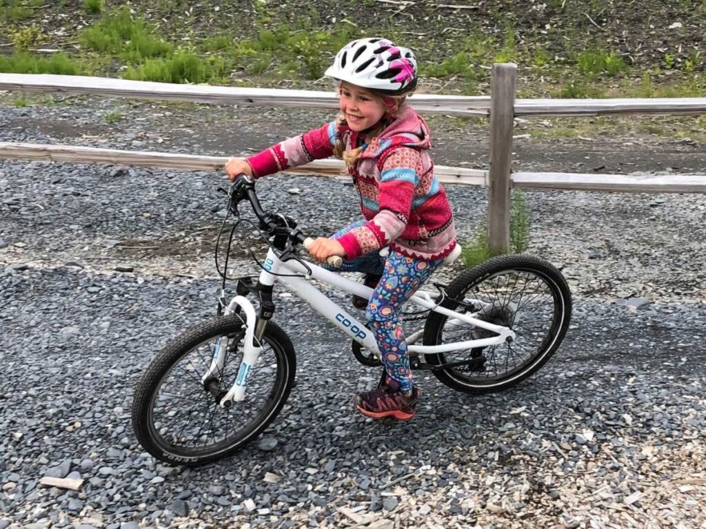 choosingkidsbikeREIbike A girl rides a REI Co-op bike