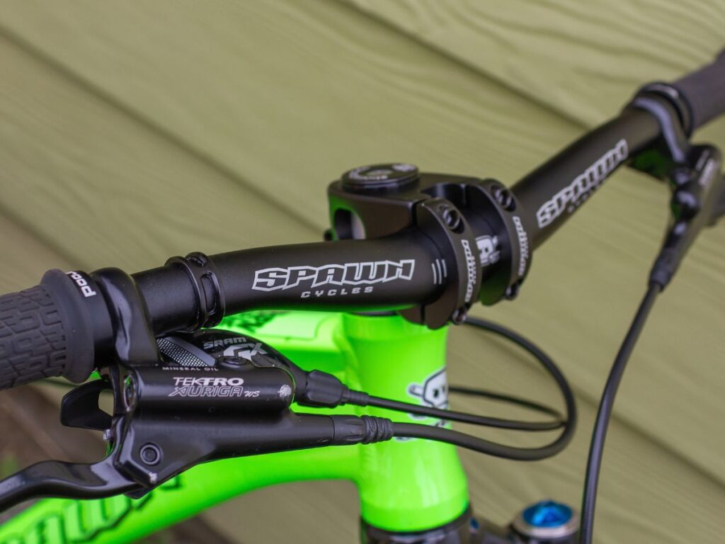 choosingkidsbikehandlebar Handlebar of a bike with a green frame.